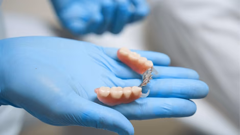 Dentist holding a partial denture